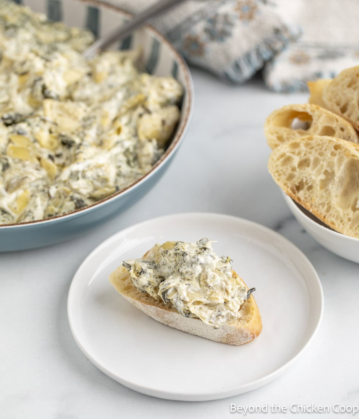 A slice of bread topped with a creamy dip.