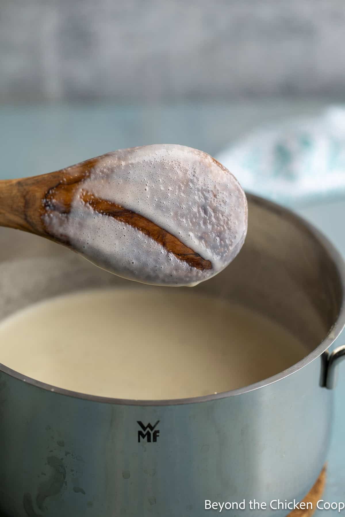 A wooden spoon coated with a custard mixture.