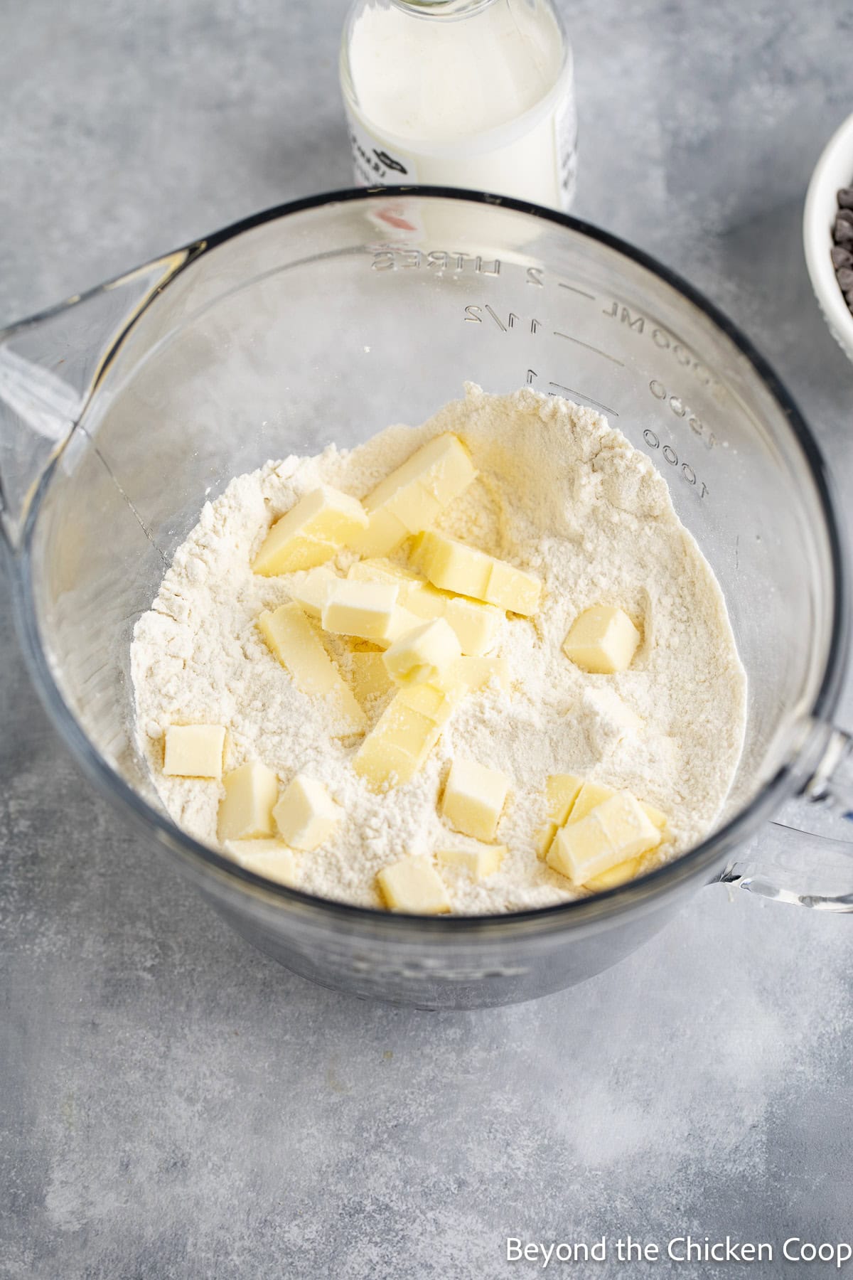 Flour and butter in a glass bowl.
