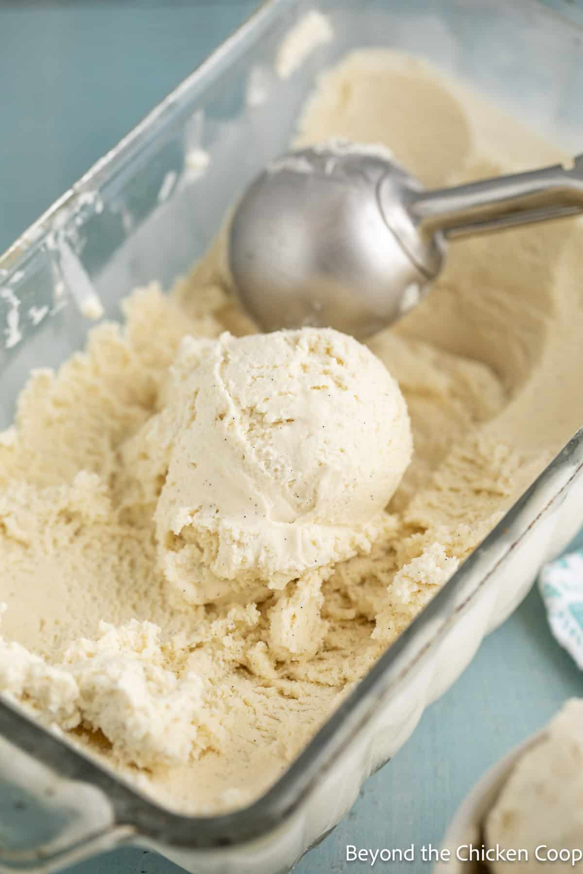 Scooping vanilla ice cream.