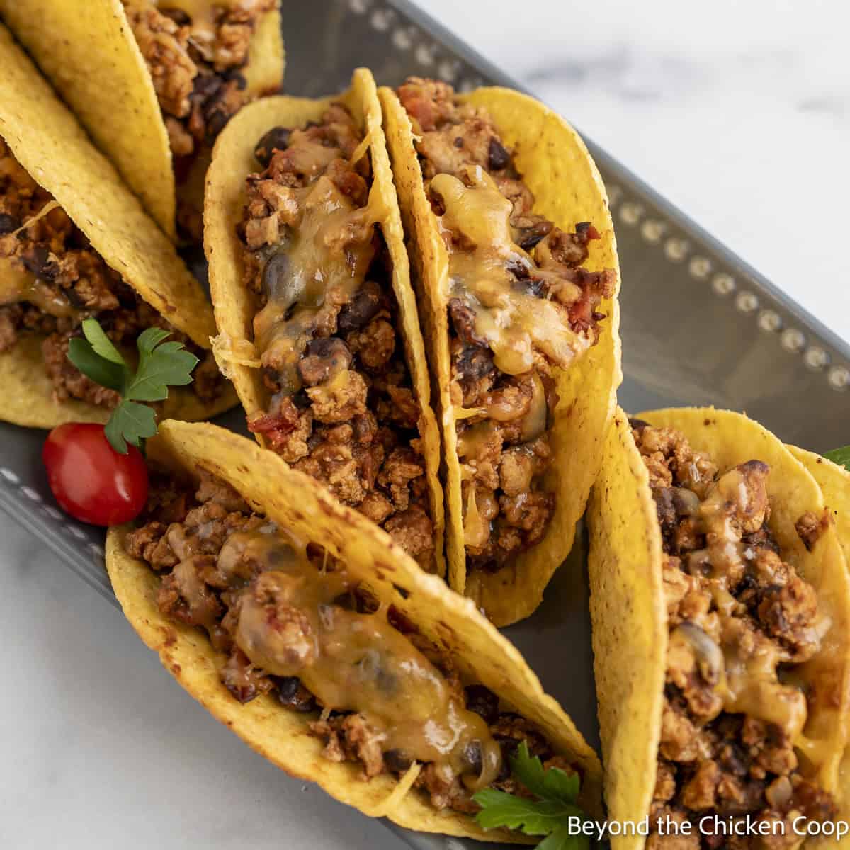 Tacos filled with ground turkey on a large platter.