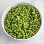 Buttered Peas in a white bowl.