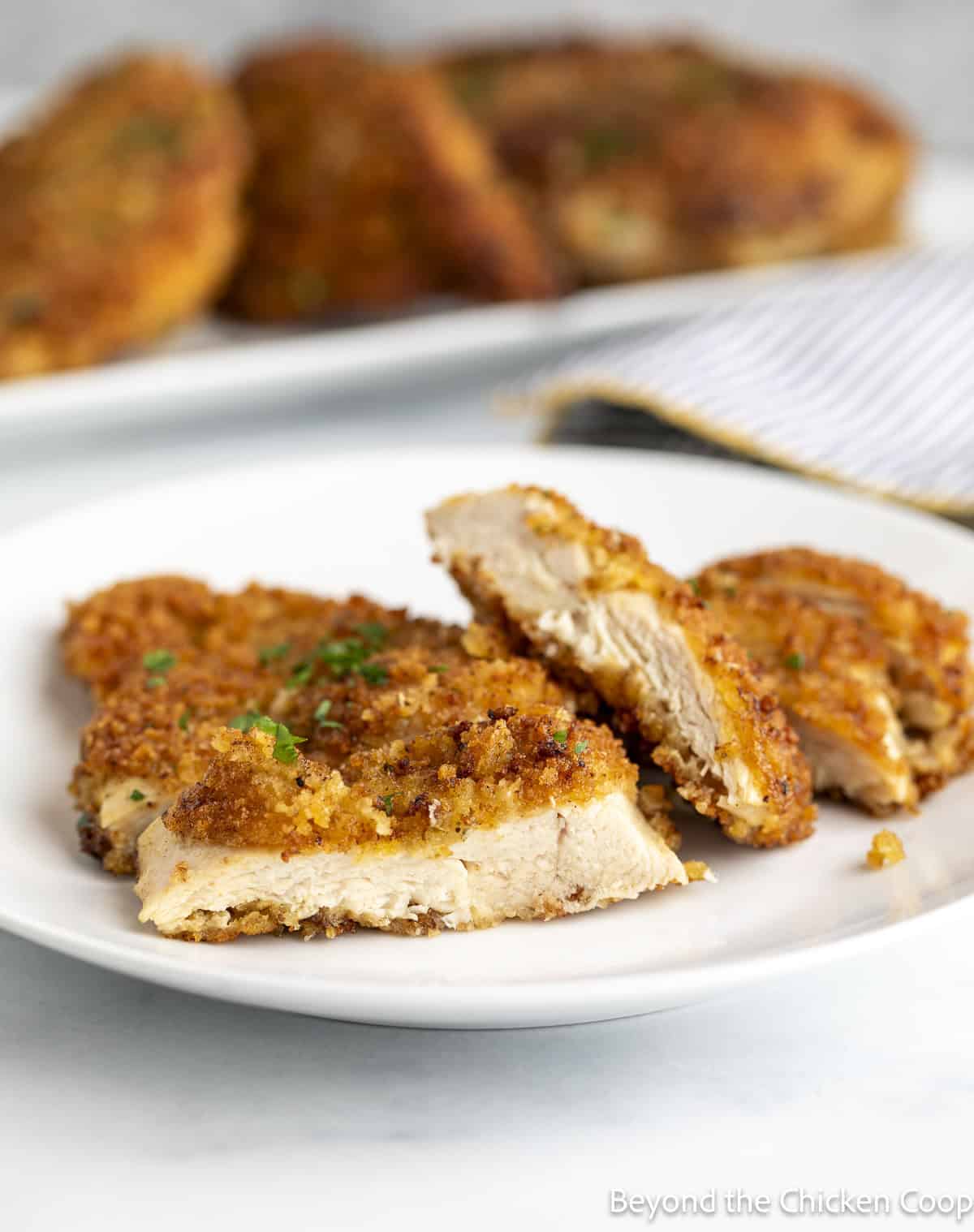 Sliced chicken breasts with a crunchy coating.