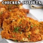 Fried chicken breasts on a white platter.