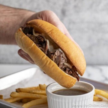 Crock Pot French Dip sandwich over a small bowl with au jus.