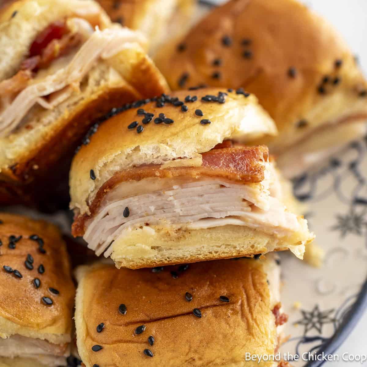 A pile of Turkey Bacon Sliders on a plate. 