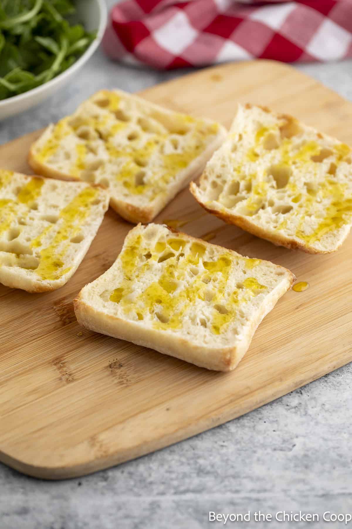Ciabatta rolls with olive oil drizzled over the inside of the rolls.