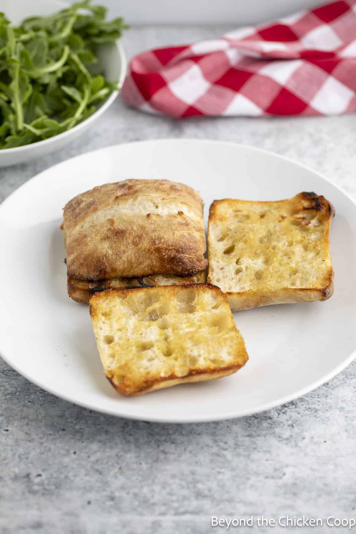 Grilled rolls on a white plate.