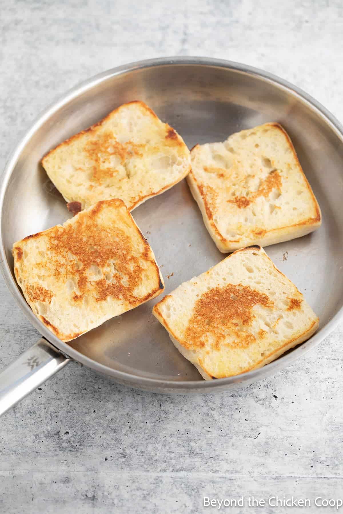 Toasted buns in a skillet.