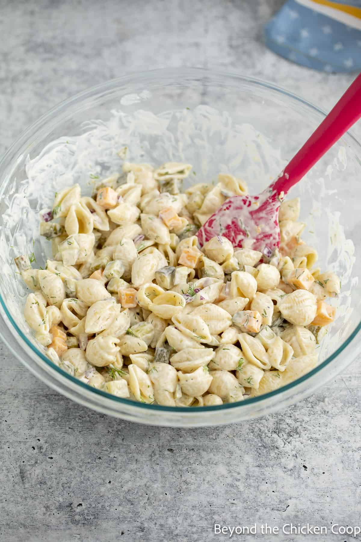 A pasta salad in a large glass bowl.