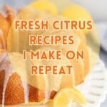 A lemon cake with lemon slices on a cake stand.