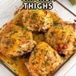 Baked chicken thighs in a glass baking dish.