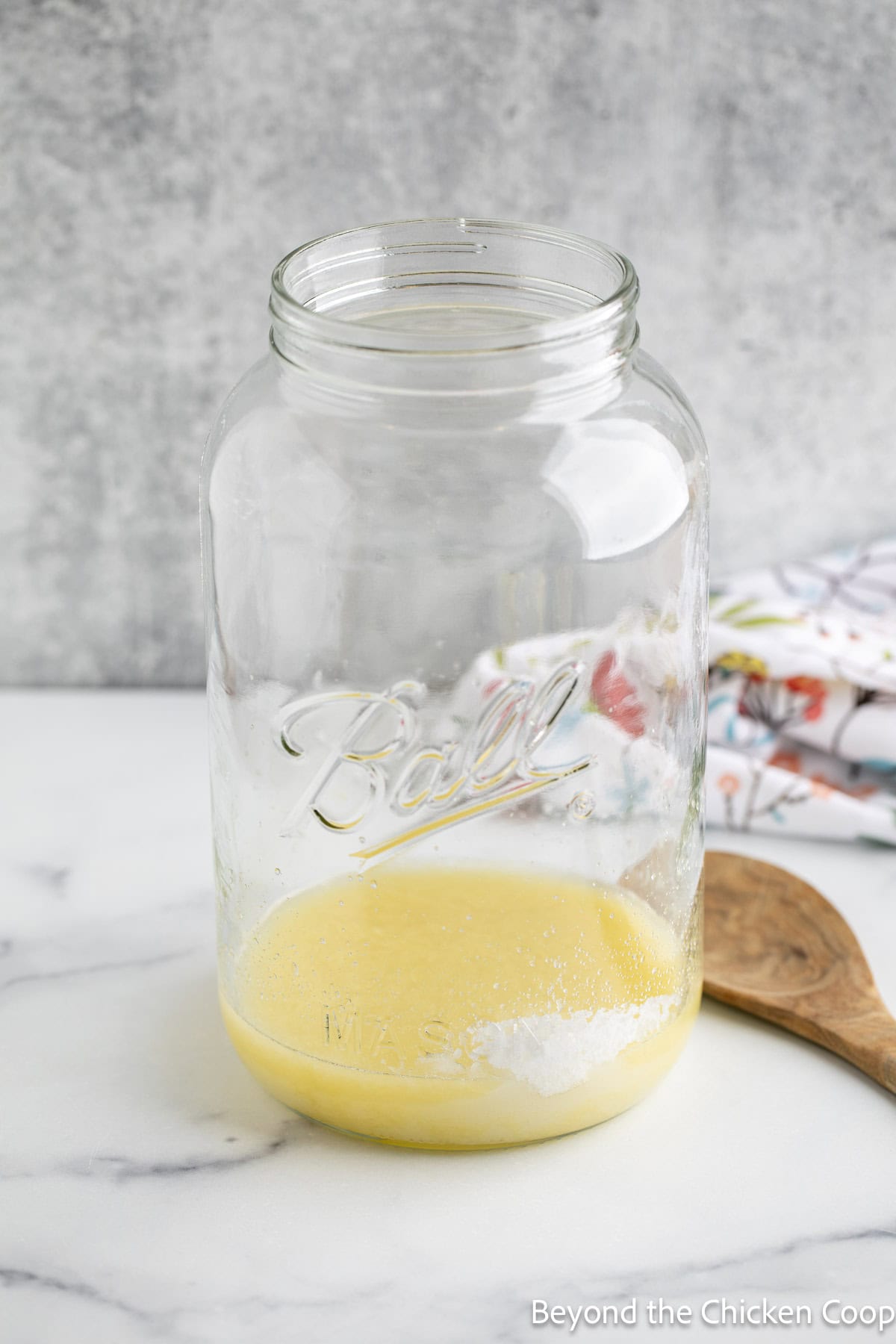 Lemon juice and sugar in a glass jar.