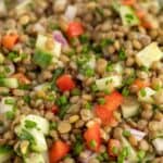 Green lentils, cucumbers, and bell peppers combined together in a salad.