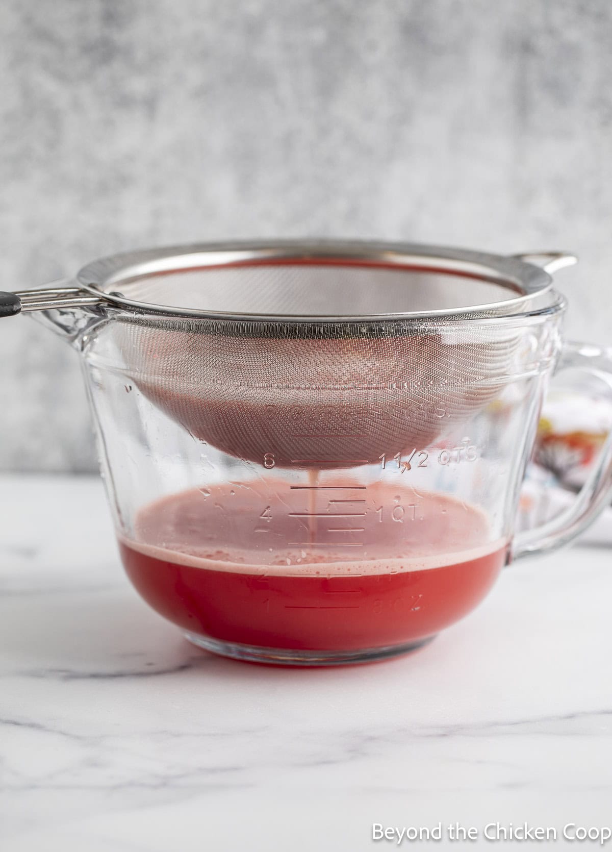 Straining watermelon juice.