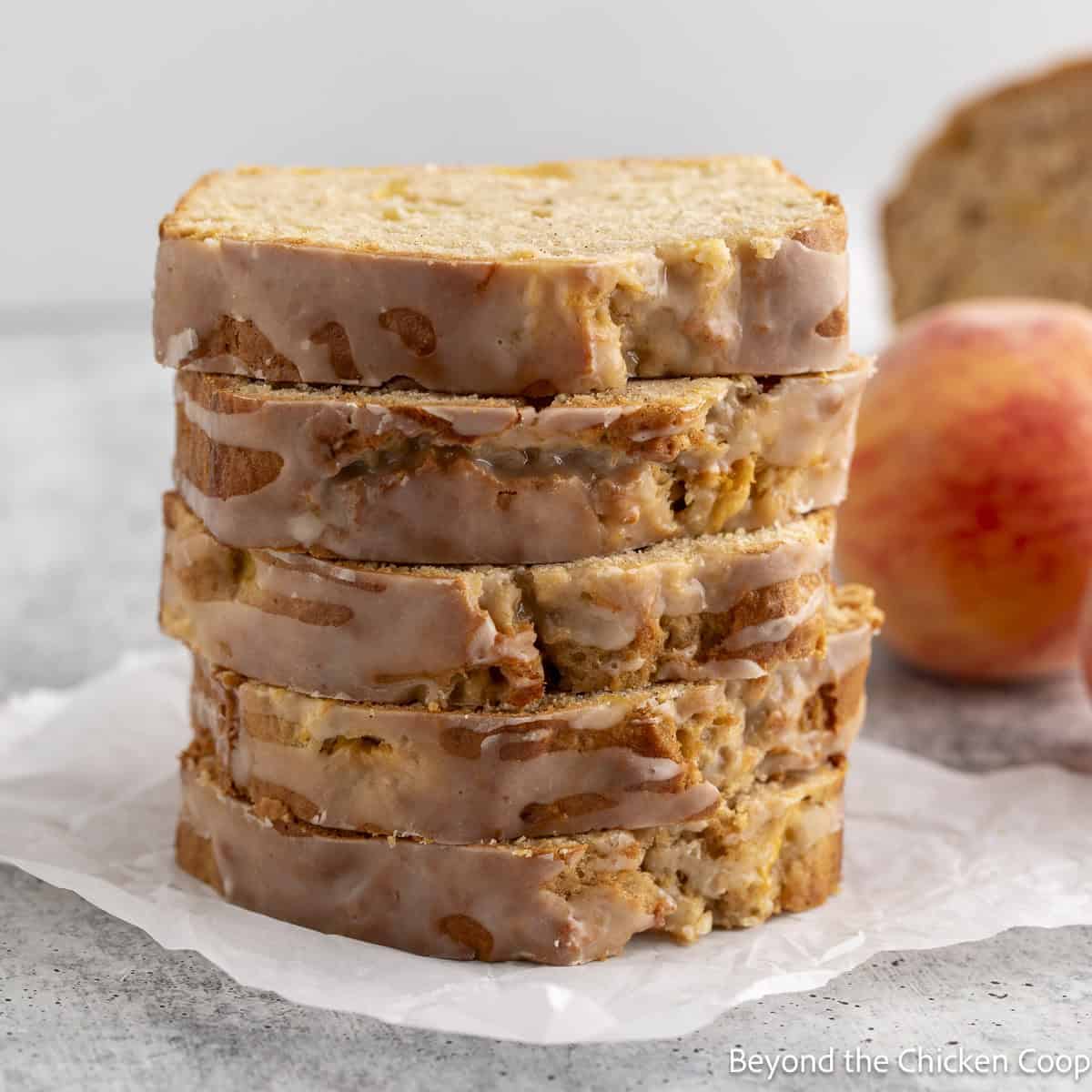 Slices of Homemade Peach Bread stacked on top of each other.