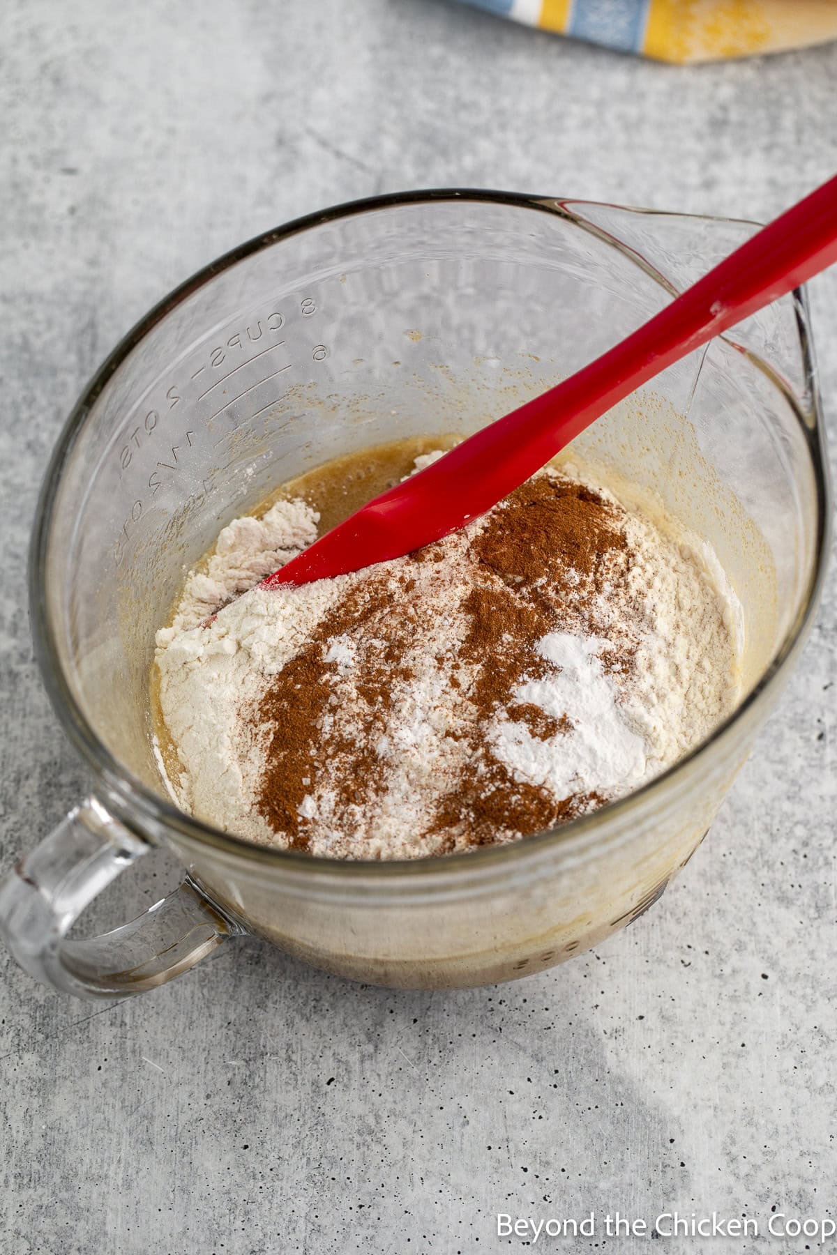 Mixing flour into a bread batter.