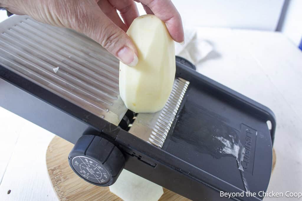 Slicing potatoes with a mandoline.