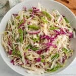 A white bowl filled with Asian Slaw.