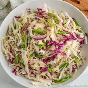 A white bowl filled with Asian Slaw.