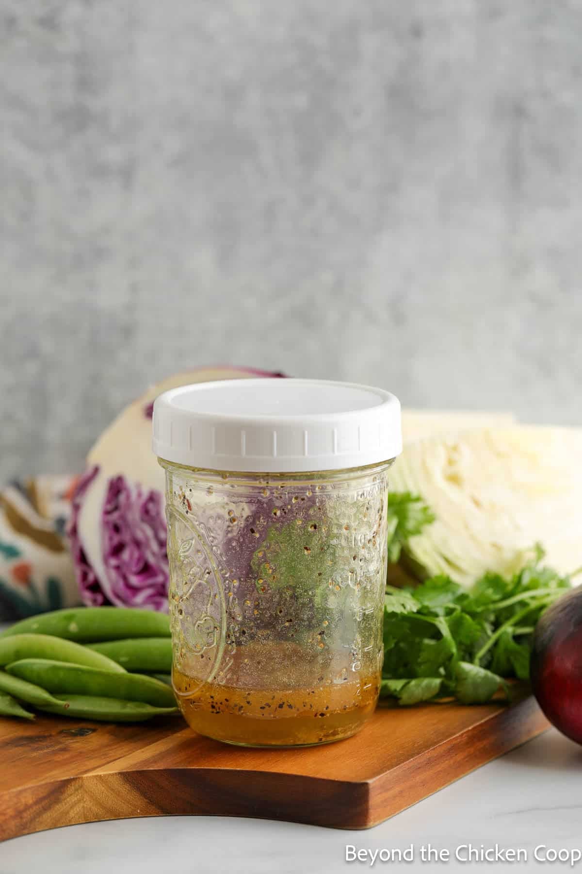Dressing in a glass jar with a white lid.