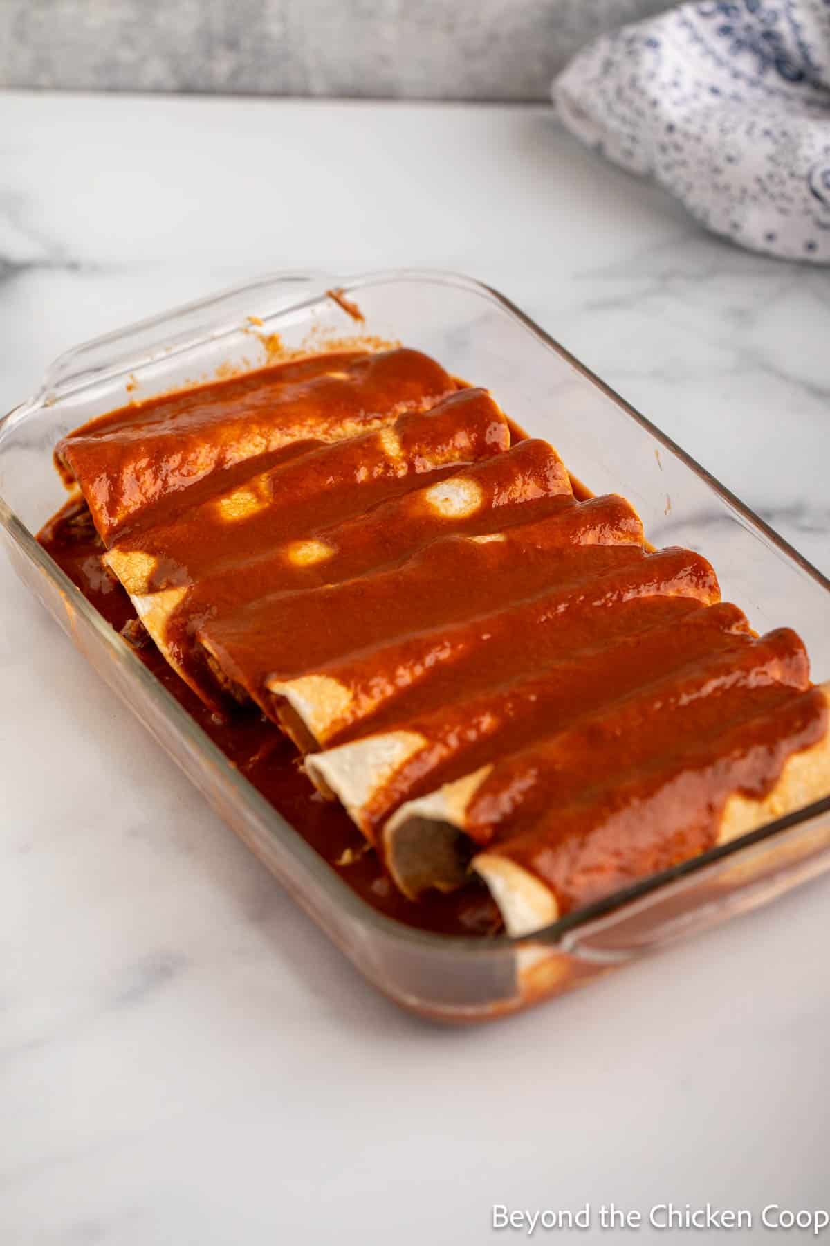 Enchiladas in a glass dish.