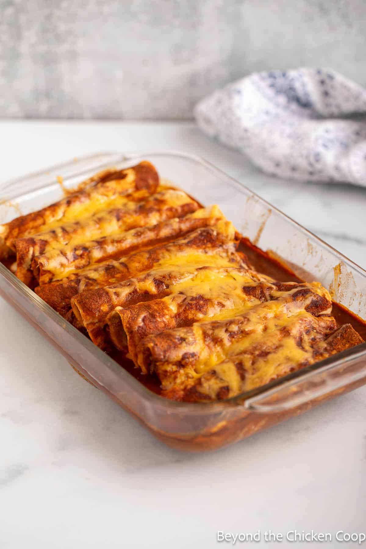 Baked enchiladas in a glass dish.