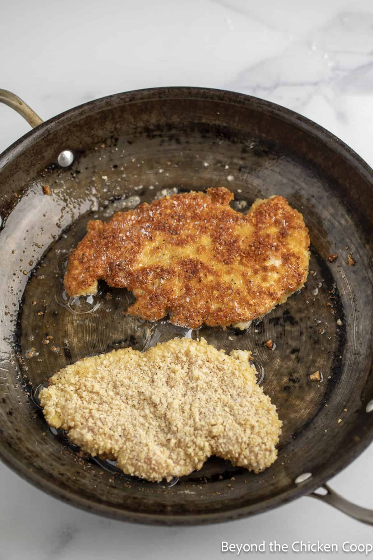 Cooking chicken in a skillet.