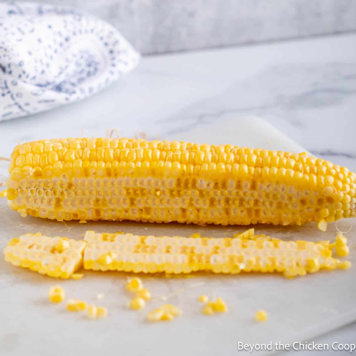 Cutting corn off the cob.