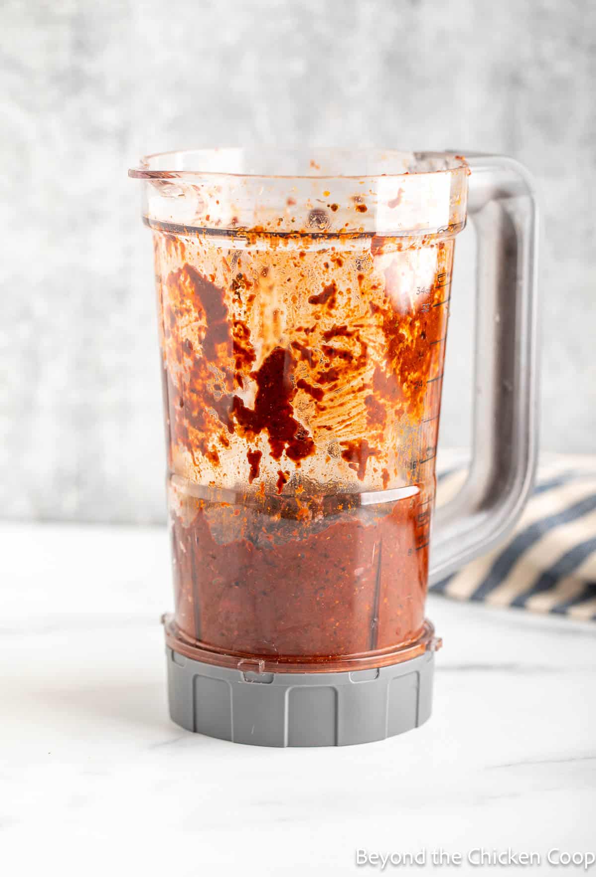 A blender filled with a chile paste.