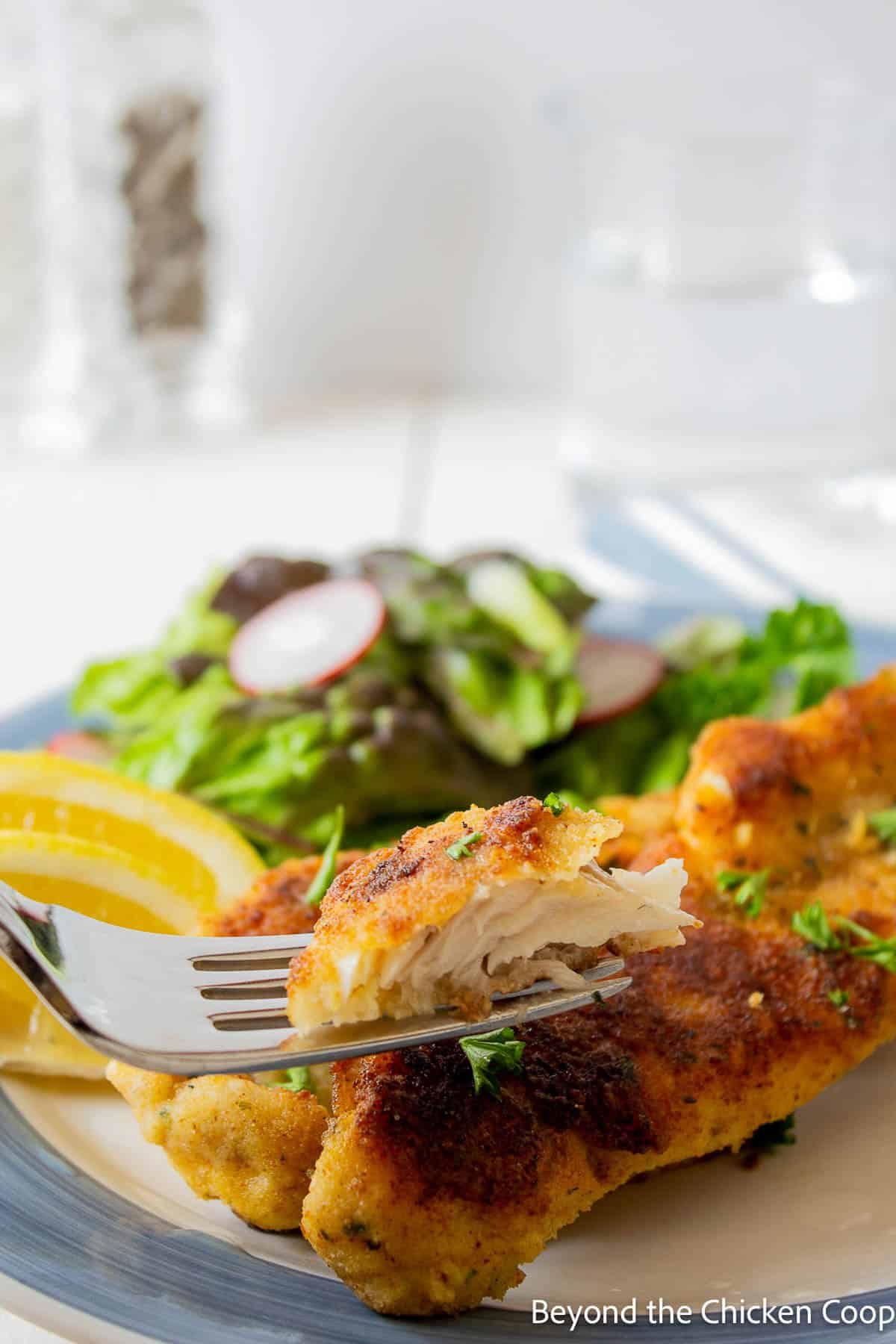 Pan Fried Walleye A fork with fried fish.