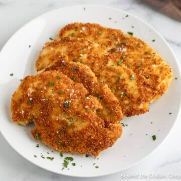 Crispy Parmesan Crusted Chicken on a white plate.