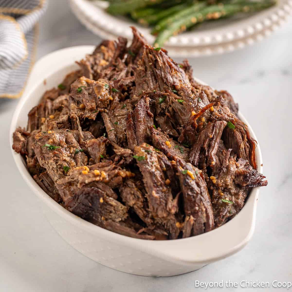 Roasted Shredded Beef in a white dish.
