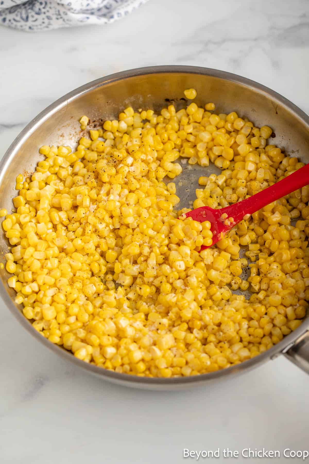 A skillet with corn.