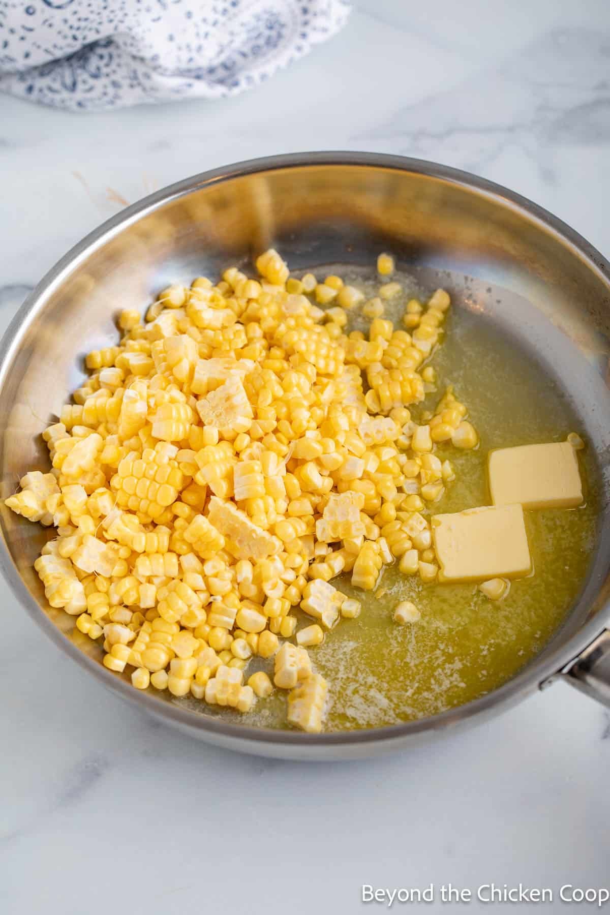 Corn kernels in skillet with butter.