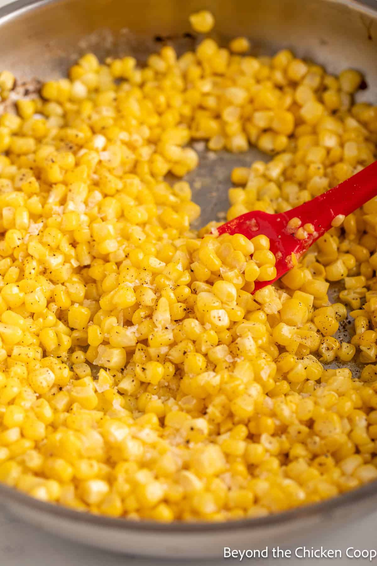 Corn with butter in a skillet.