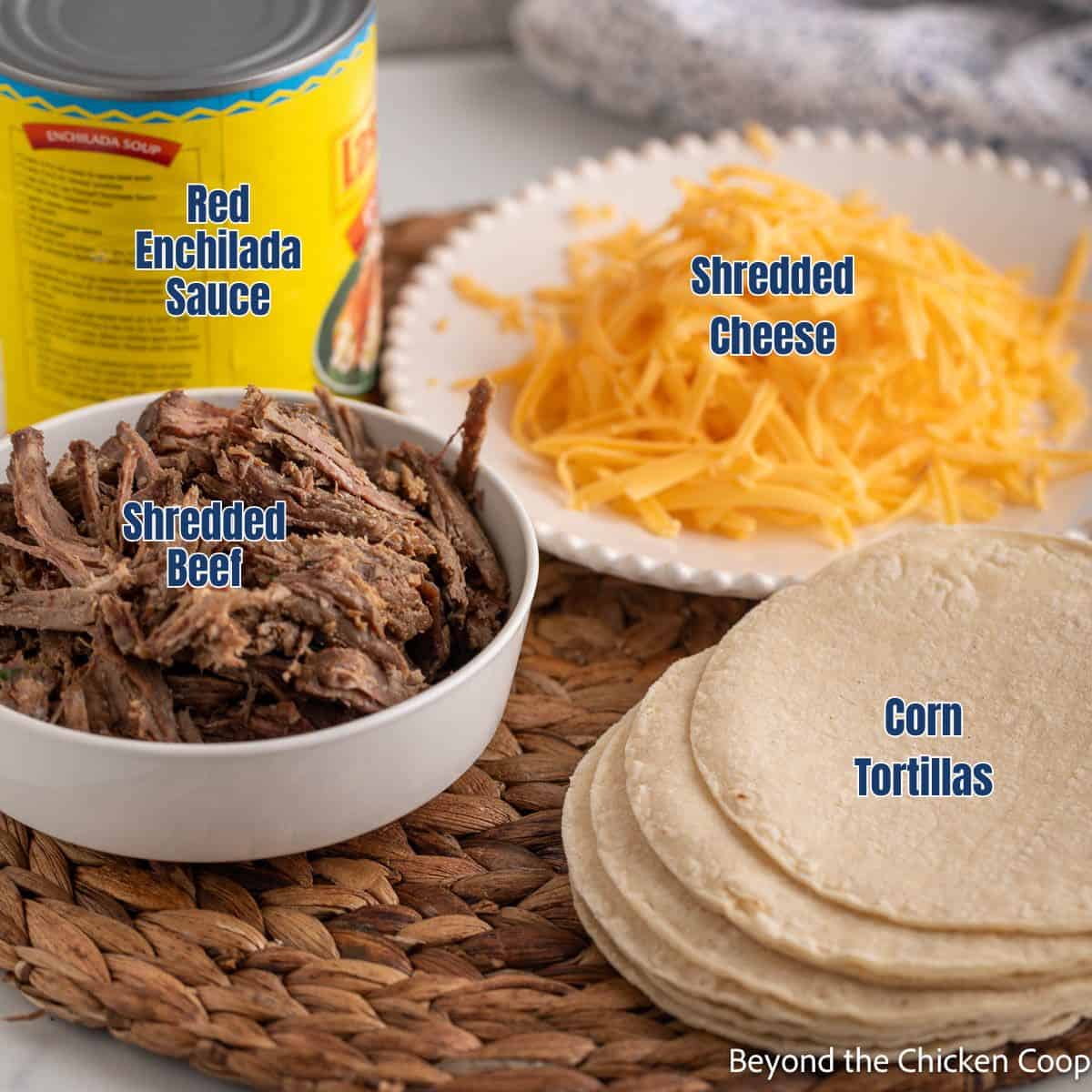 Shredded beef, cheese, tortillas, and a can of enchilada sauce.