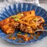 Two Shredded Beef Enchiladas on a blue plate.