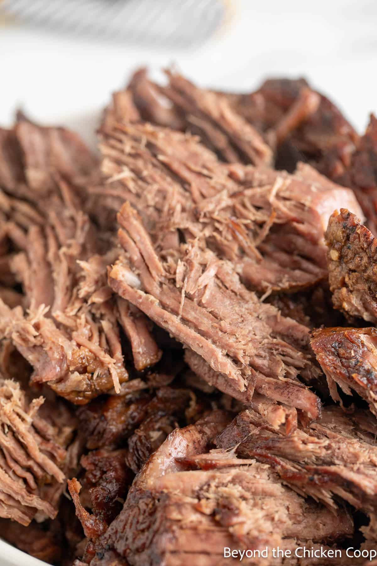 Shredded chuck roast in a bowl.