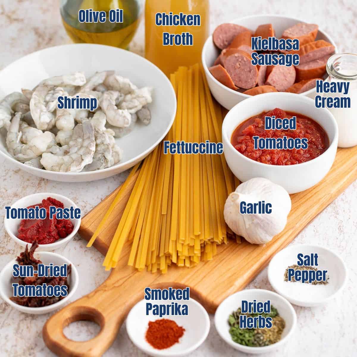Bowls filled with shrimp, sausage, seasonings, and other ingredients.