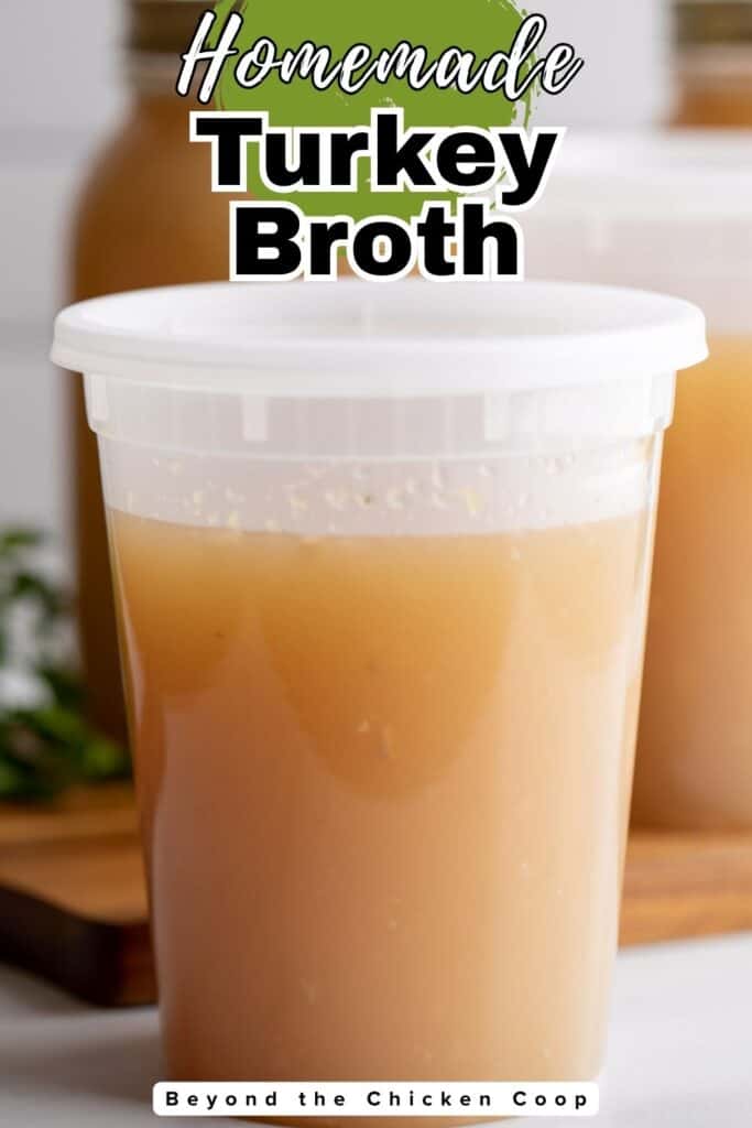 A plastic container filled with turkey broth.